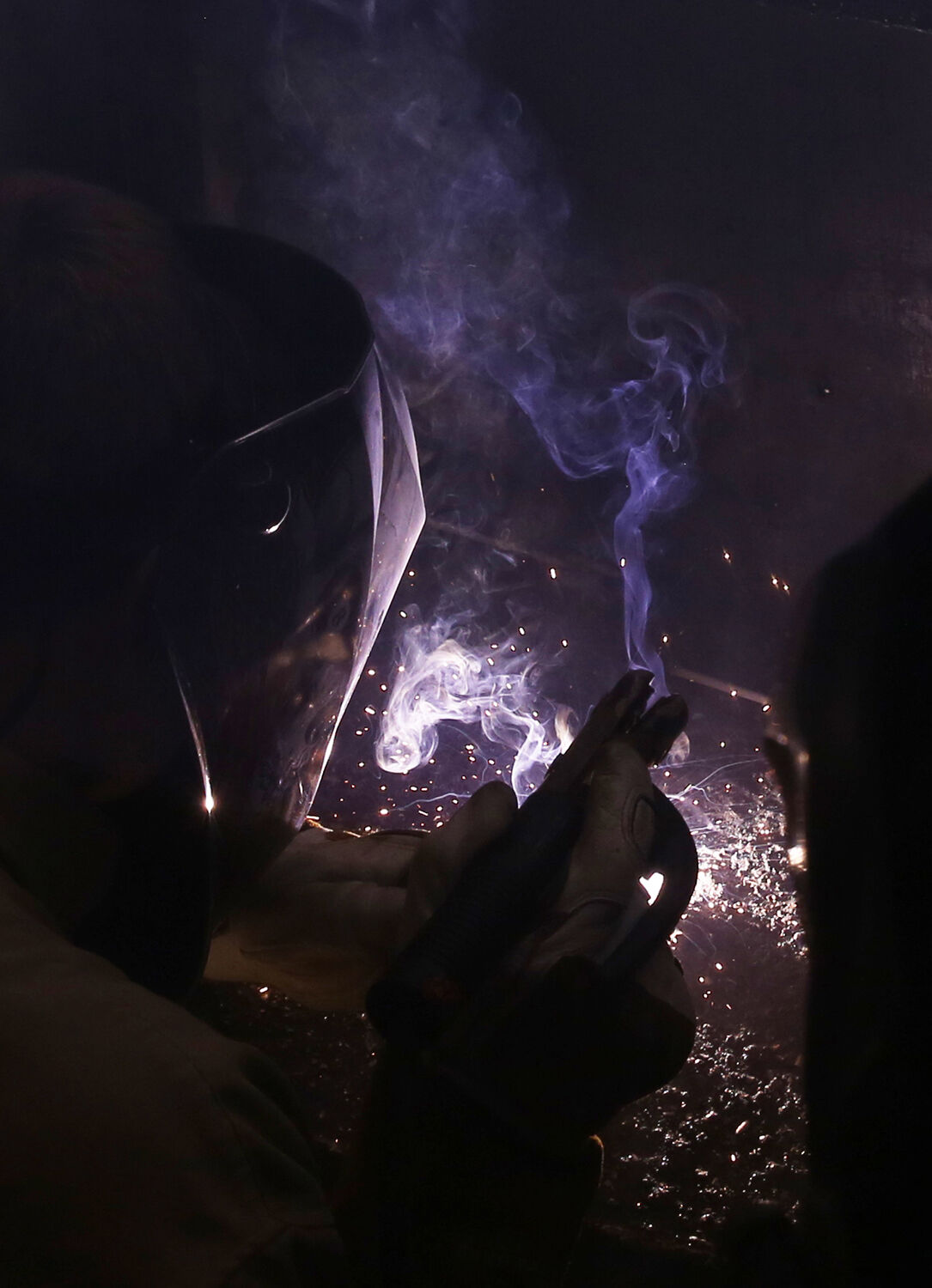 Lance Rabel sits in one of the welding booths